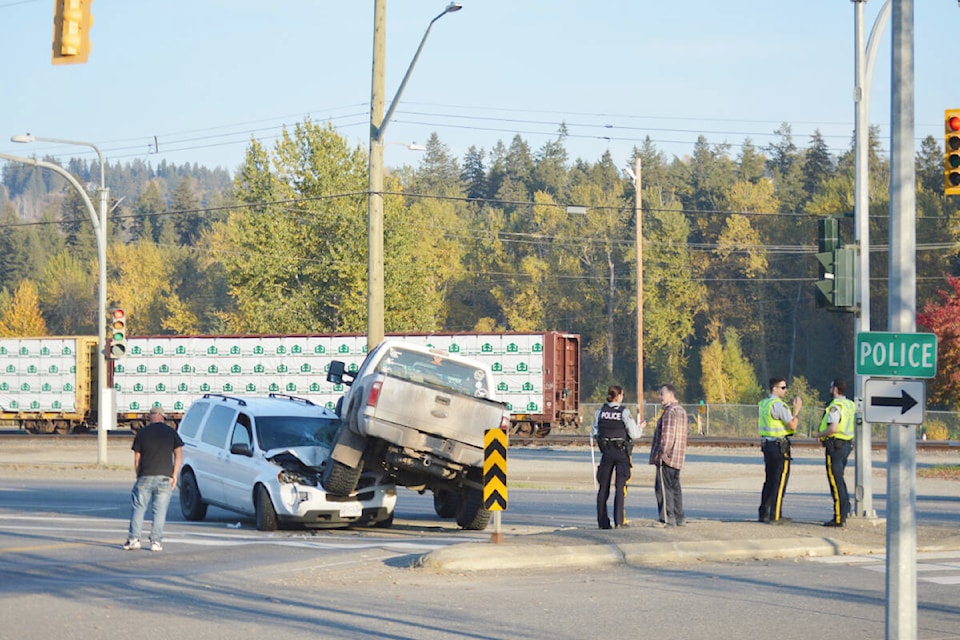 Police await a tow truck following a crash near the intersection of Highway 97 and Carson Avenue near the Quesnel RCMP Detachment Friday afternoon Oct. 7. (Rebecca Dyok photo — Quesnel Observer)
