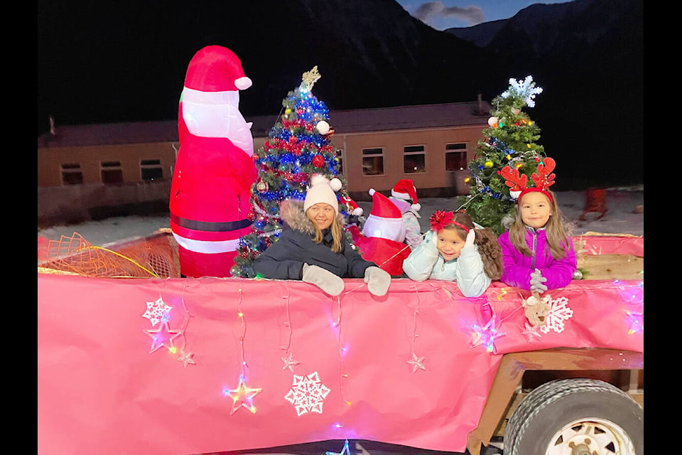The Santa Claus Parade held Saturday, Dec. 10 in Bella Coola was a bit hit for the community here Kirsten Milton-Tallio, Journey Hans and Raylea Moody enoy a ride on a float. (Photo submitted)