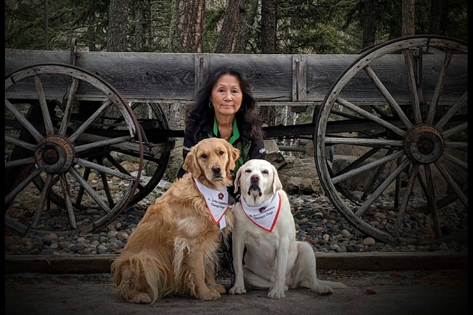 Karen Wright with her therapy dogs, Maya (l) and Sophie. Wright is hoping to get the word out and encourage more people to apply to the program. (Photo submitted)