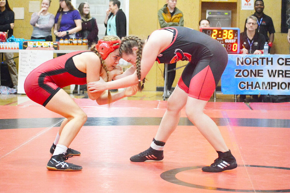 Morgan Boileau, 14, of Sir Alexander Mackenzie Secondary School spars in an exhibition match against Abby Ostrom of the Lake City Falcons at the North Central Zone Wrestling Championships held Friday, Feb. 10 in Williams Lake. (Monica Lamb-Yorski photo - Williams Lake Tribune)