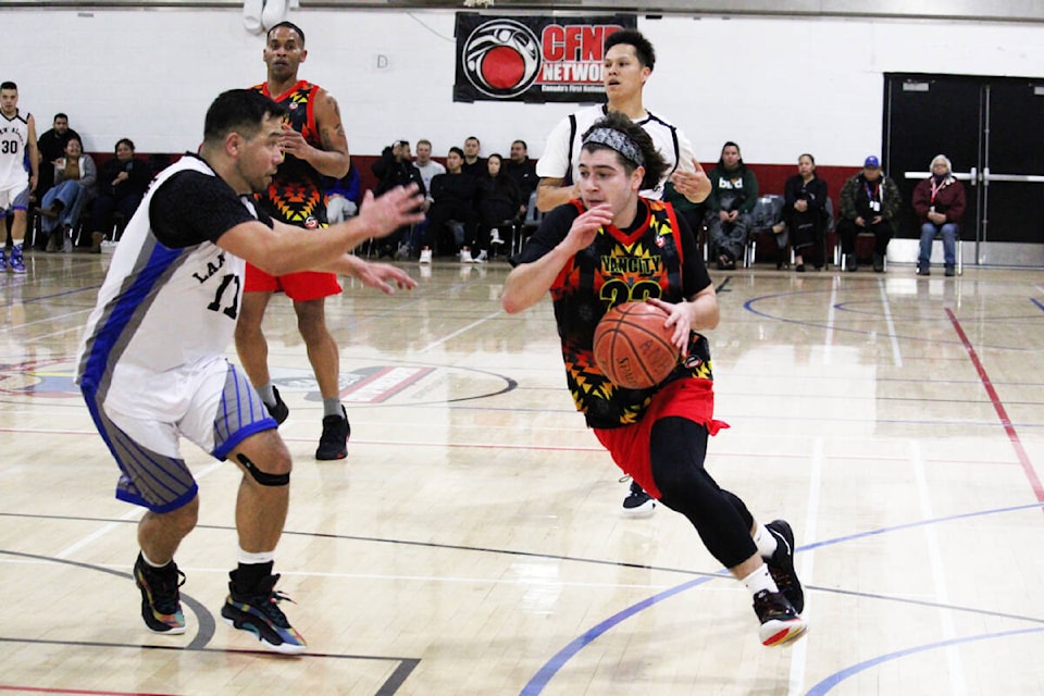 Burnaby’s Kobe McNight drives to the basket against Lax Kw’alaams’ Taylor Ross during Seniors Division action on Day 2 of the All Native Basketball Tournament. (Thom Barker photo)