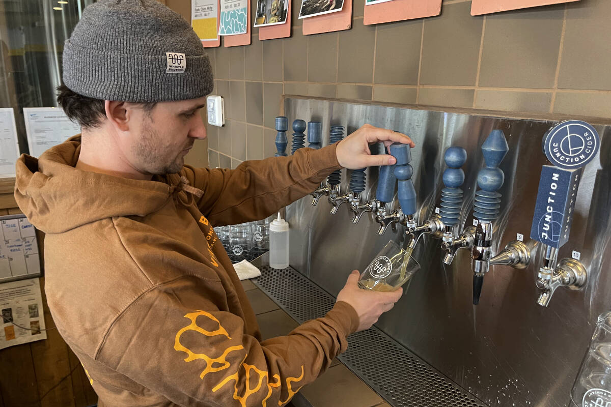 Isaiah Archer pours a pint of Whistle Buoy Brewings new AI-generated hazy pale ale. (Austin Westphal/News Staff)