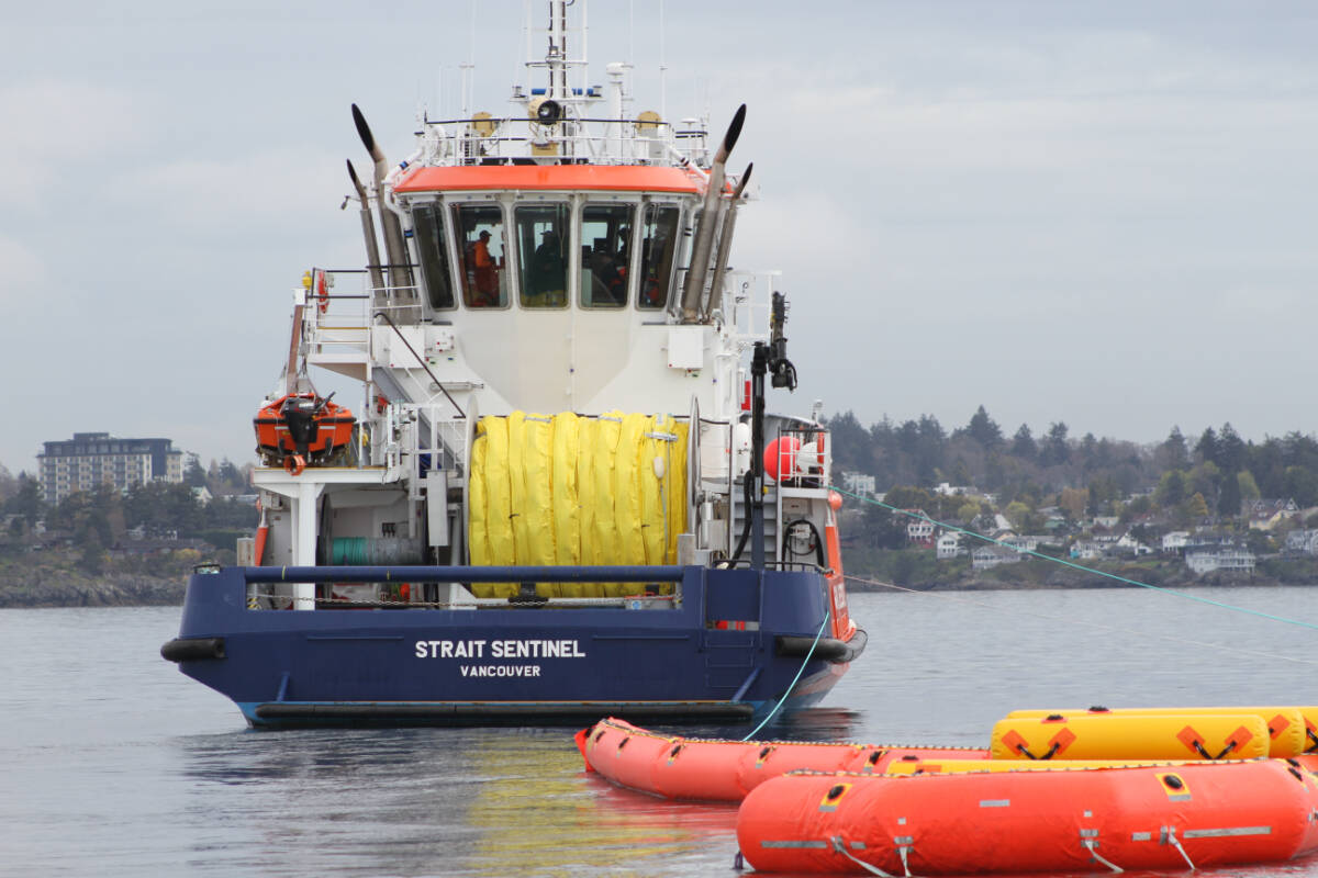 The crew of the Strait Sentinel deploys a sweep system used to collect oil off the oceans surface. (Austin Westphal/News Staff)