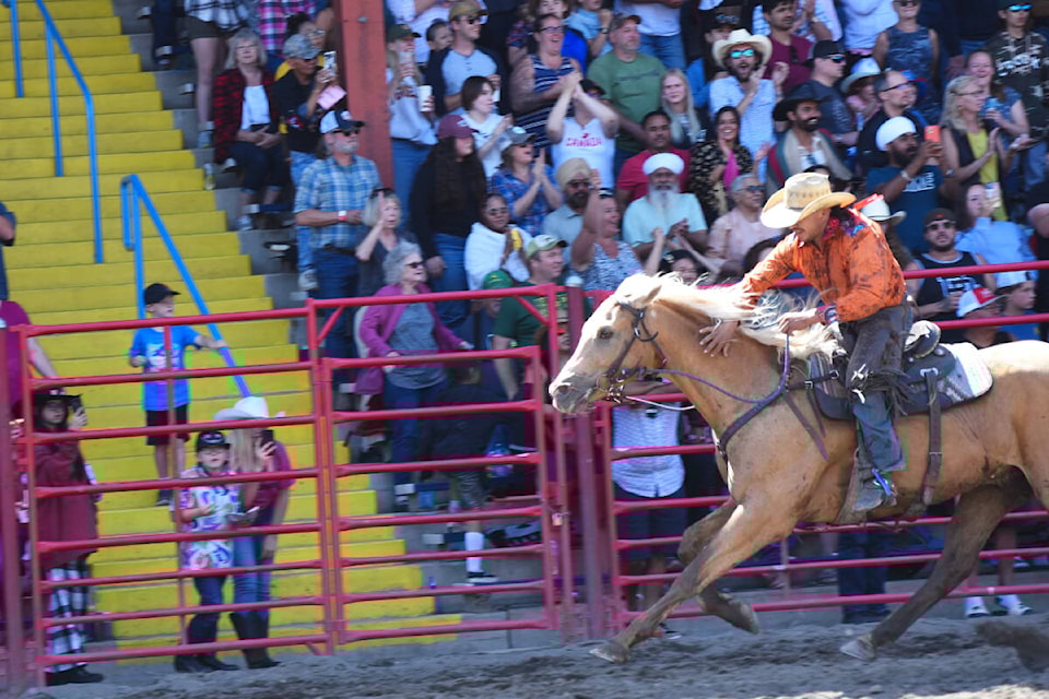 Jesse Chillihitzia of Merritt gives Qwez a pat as they cross the finish line, winning the Mountain Race during the final performance of the 95th Annual Williams Lake Stampede July 2. (Angie Mindus photo - Williams Lake)