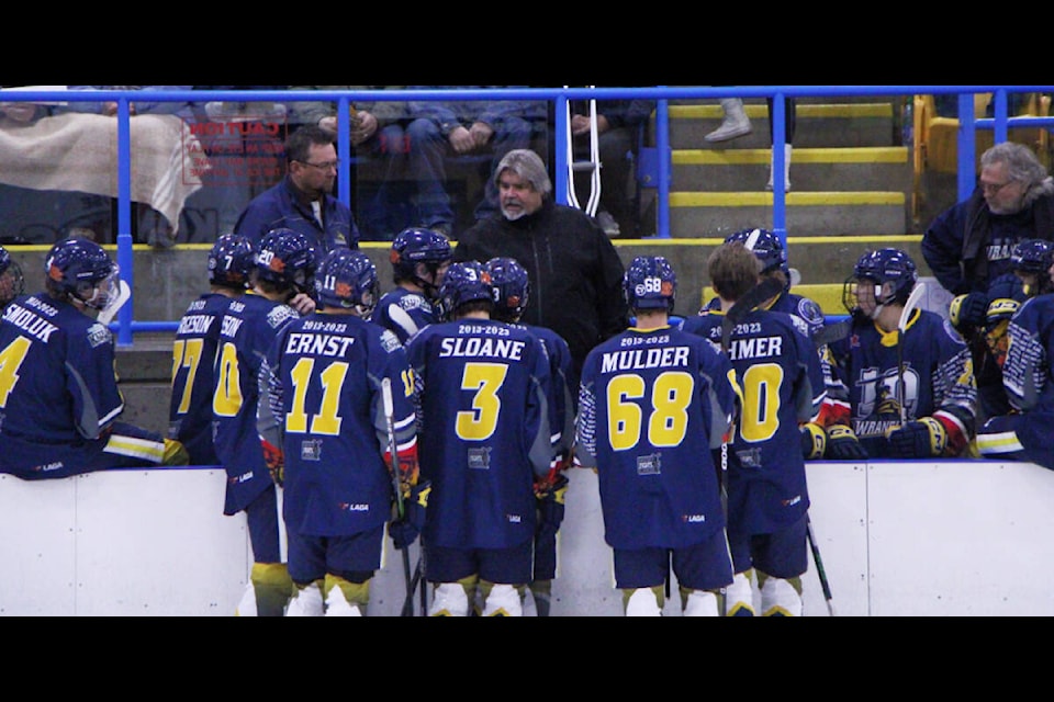 The 100 Mile House Wranglers huddle up to listen to head coach Dale Hladun during a game in September. The Wranglers have lost five games this season and won only one, largely due to frequent penalties, Hladun said. (Patrick Davies photo - 100 Mile Free Press)