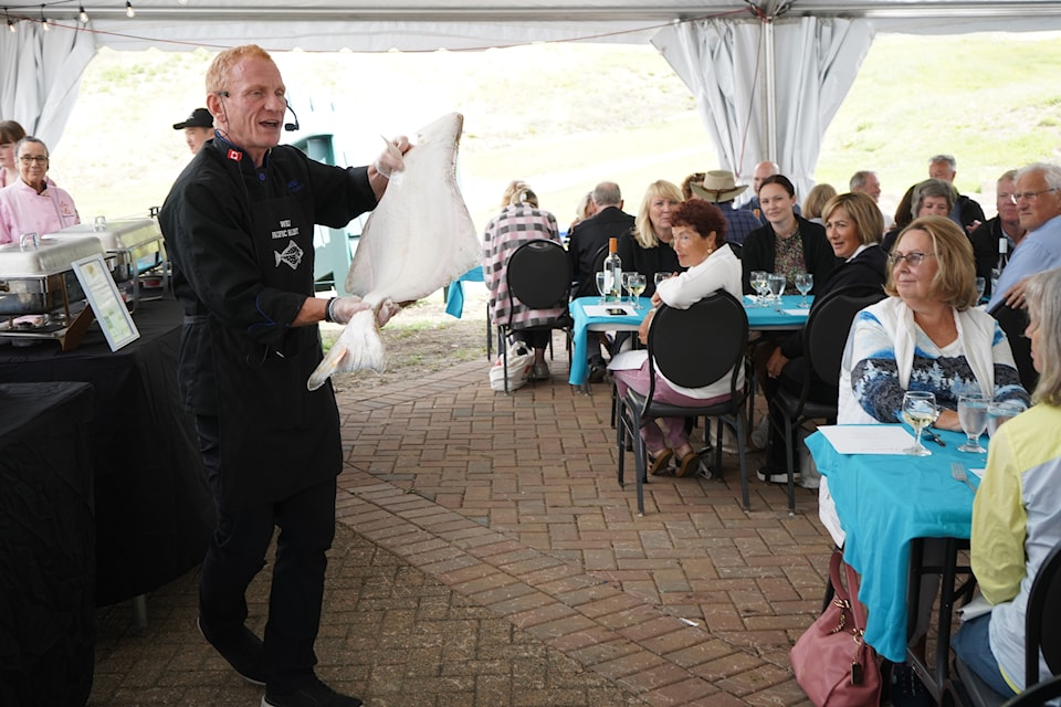 Wes Erikson with Wild Pacific Halibut shows off a freshly caught halibut at the Wild About Halibut! luncheon.