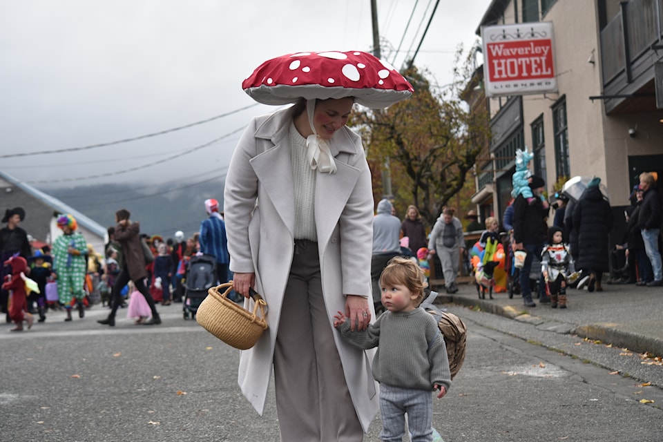 A family walks down the street in Cumberland on Halloween.