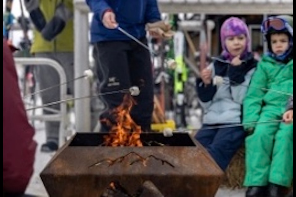 Kids enjoy s'mores around the fire at Family Day at Mt. Washington.