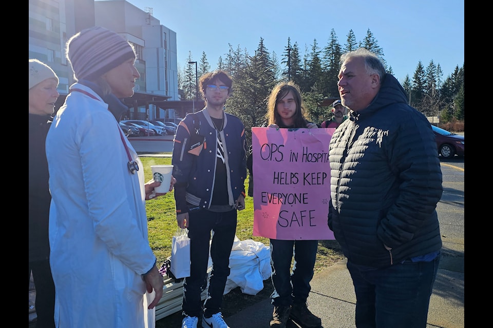 Dr. Eva Hemmerich speaks with MP Gord Johns.