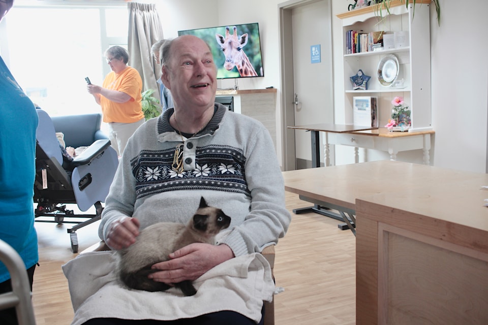 Marcus Potts holds a kitten.