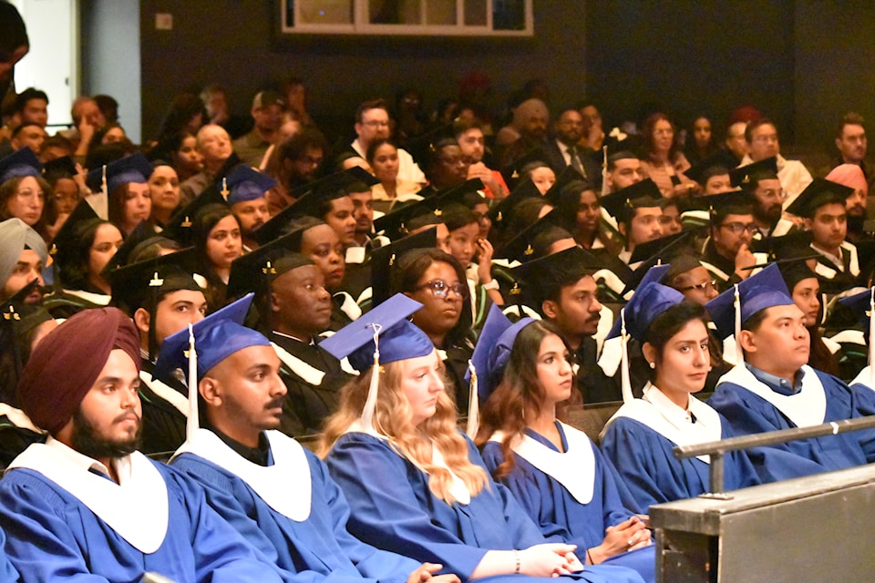 Graduates wait for their turn on stage. 