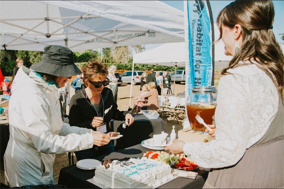 Habitat for Humanity volunteers serve cake & refreshments at a Key Ceremony held on the site of an upcoming build at 461 Hilchey in Campbell River. 