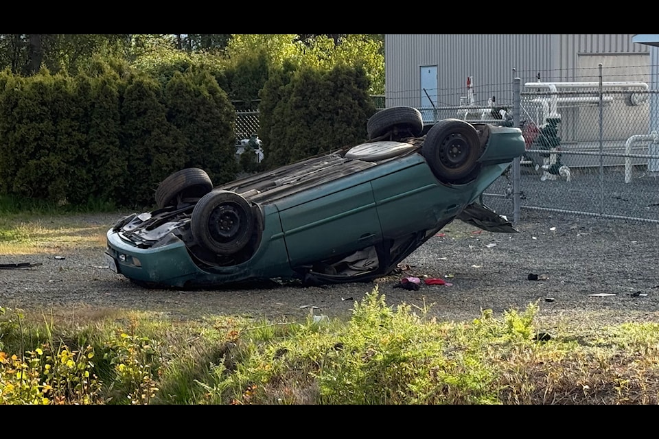 Car seen flipped on its rooftop at crash site. 