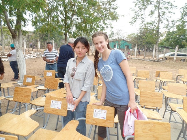 Michelle KO (left) and Kalyssa Heinrich with final delivery of new desks.