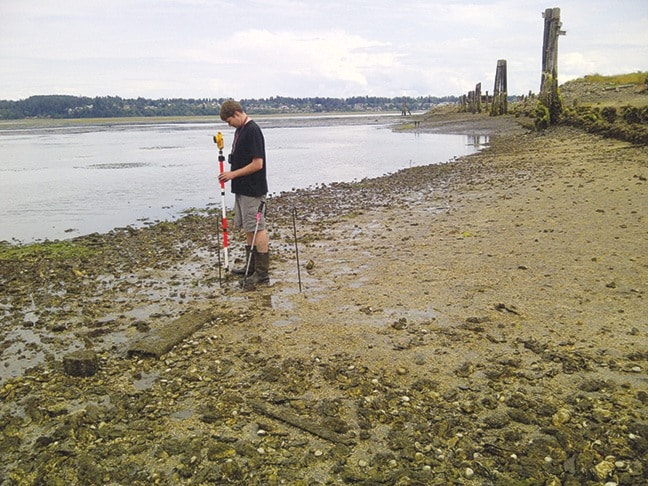 Russell Prentice, 2014 PICS summer intern surveying eelgrass in estuary.