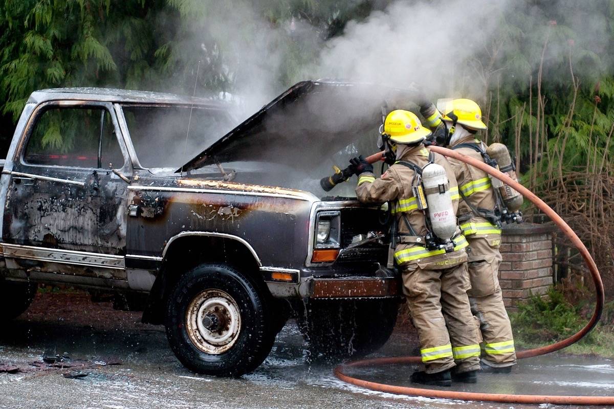 Parksville firefighters mop up the last flickers of flames under the hood of a Dodge pickup that caught fire in the driveway of a home in San Pareil on Thursday morning, Jan. 11, 2018. — J.R. Rardon photo