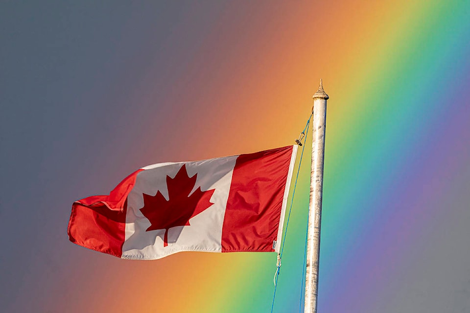 The flag flying at the Courtenay Legion was especially stunning with the rainbow in the background. Photo by Richard Boyle