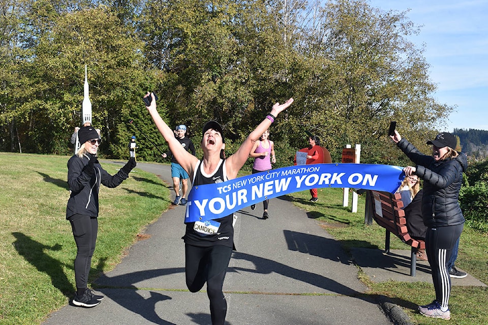 Candice Wheeldon celebrates as she crosses the finish line to complete her virtual New York City Marathon Sunday, Nov. 1. Photo by Terry Farrell