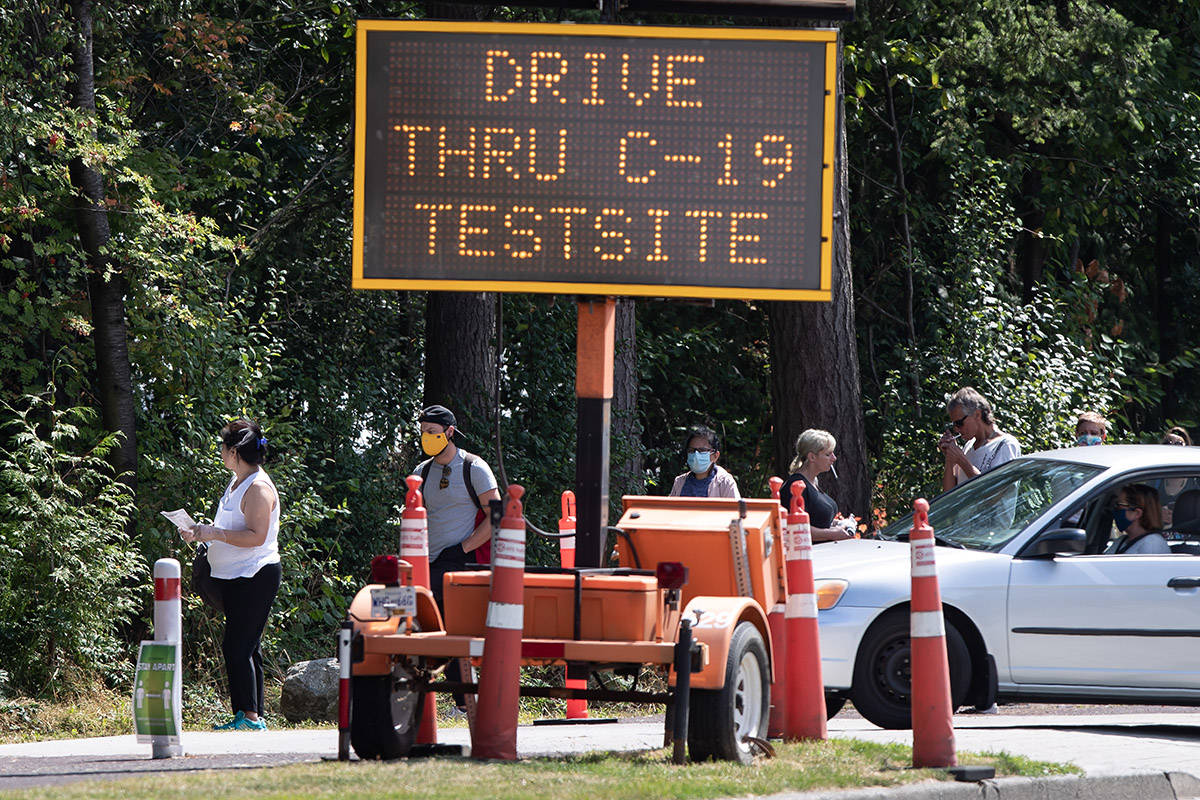 People wait in line at a COVID-19 testing facility in Burnaby, B.C., on Thursday, August 13, 2020. THE CANADIAN PRESS/Darryl Dyck