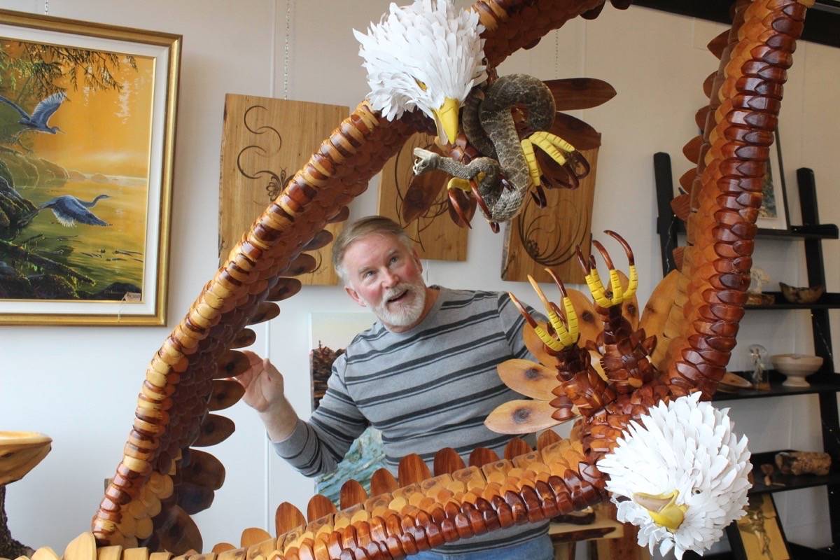 Comox artist Wes Seeley is pictured with his newest creation at Designer Woodworks in Courtenay. Scott Stanfield photo