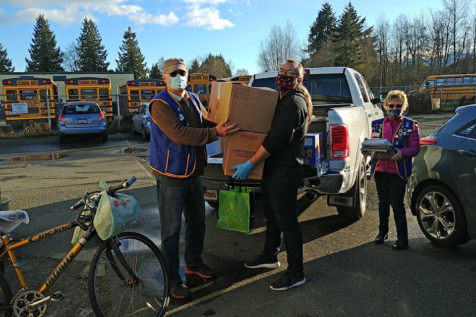 The Comox Valley Monarch Lions Club donated a pickup load of winter clothing from the club members and friends of the Club to the Comox Bay Care Society (Care-A-Van) to disburse to the less fortunate in the Valley. President Ken and Service Chair Cathy are shown giving the clothes to Peter from the CBCS.