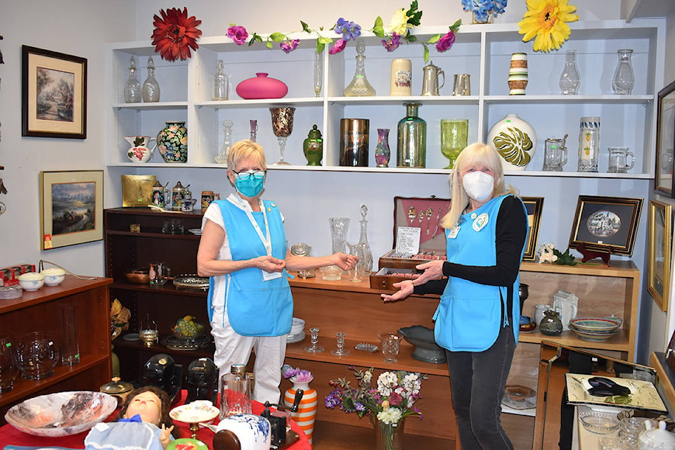 Sandra Kryschuk and Kathy Kelly show some of the treasures available in the “specialty section” at the Auxiliary for Comox Valley Healthcare Cottage Thrift Shop. Photo by Terry Farrell