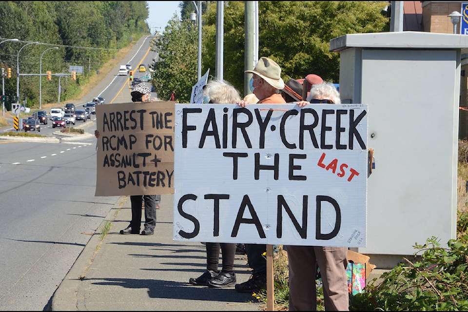 People with placards lining the street. Photo by Mike Chouinard