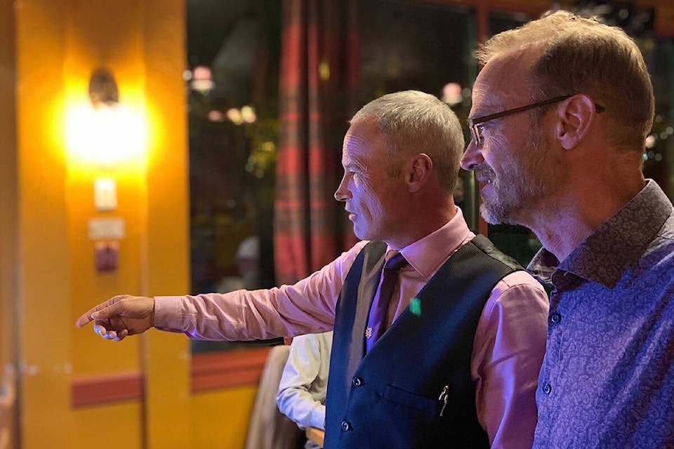 PPC candidates Rob Anderson (Esquimalt-Saanich-Sooke) and David Hilderman (Saanich-Gulf Islands) watch the results on election night at a campaign event in Langford. (Megan Atkins-Baker/News Staff)