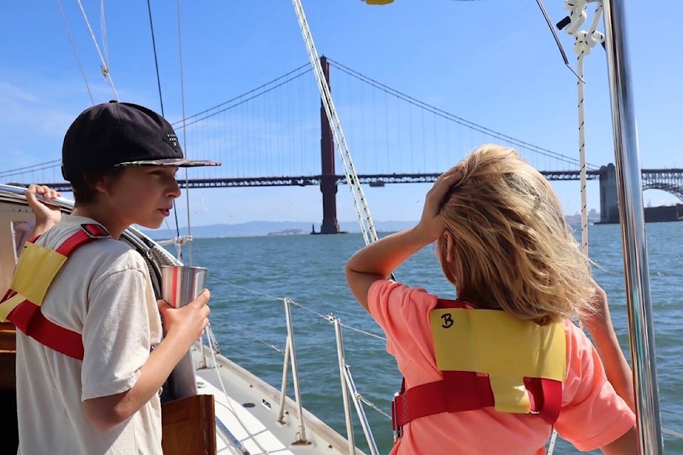 Thomas and Bentley look up as the Meraki sails under the Golden Gate Bridge. (Kate Coles/Cruising Meraki)