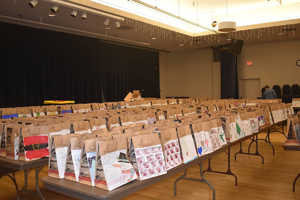 Hundreds of holiday-themed bags await filling at the 40th Earl Naswell Community Christmas Dinner. Photo by Erica Farrell