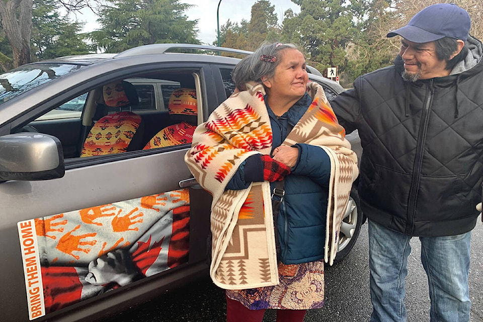 Kevin ‘Bear’ Henry’s mother, Eileen Henry (left) is comforted by uncle James Henry as the vigil for their missing loved one begins in the morning on Jan. 8. (Megan Atkins-Baker/News Staff)