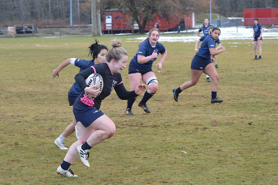 Kickers scrumhalf Lauren Sargent breaks away from James Bay Athletic Associate defenders in BCRU Division II League play, Saturday in Cumberland. Photo by Brandon Hudson