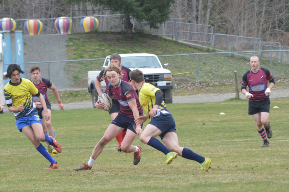 Kickers flyhalf Nick Gilmour makes a move on a Chilliwack defender. Photo by Kai Mills.