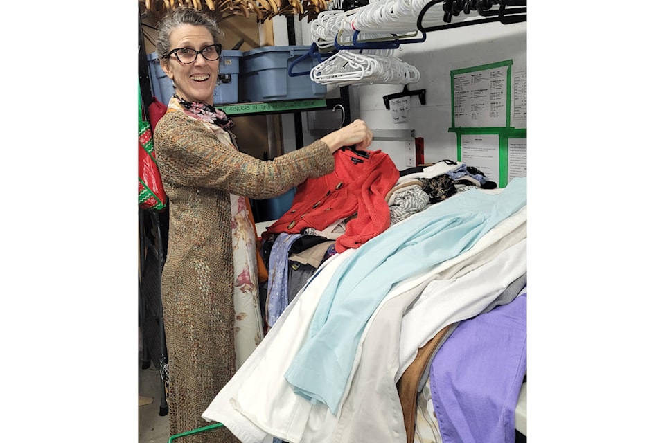 Lillian Winslow helps with sorting and hanging clothes at the Too Good To Be Threw 5th Street location. Photo supplied