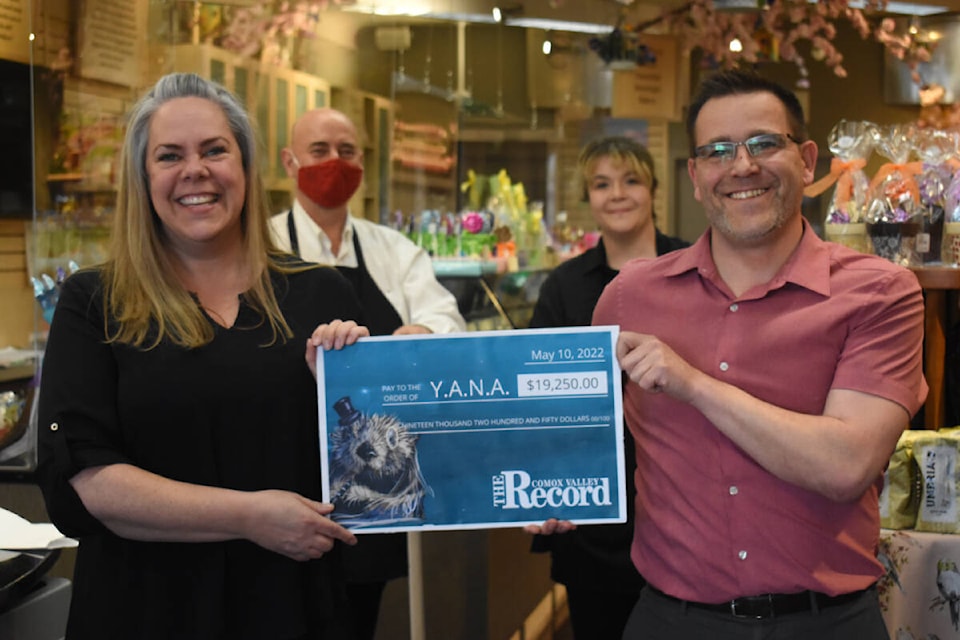 YANA executive director Kelly Barnie accepts a cheque for $19,250 from Comox Valley Record publisher Artur Ciastkowski, with Hot Chocolates owner, Jorden, and team leader, Shuka, looking on. The proceeds came from the purchase of Valley Vonka chocolate bars by Comox Valley residents. Photo by Terry Farrell