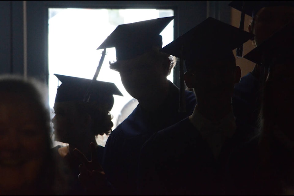 Isfeld students wait in the wings for the ceremony to begin. Photo by Mike Chouinard