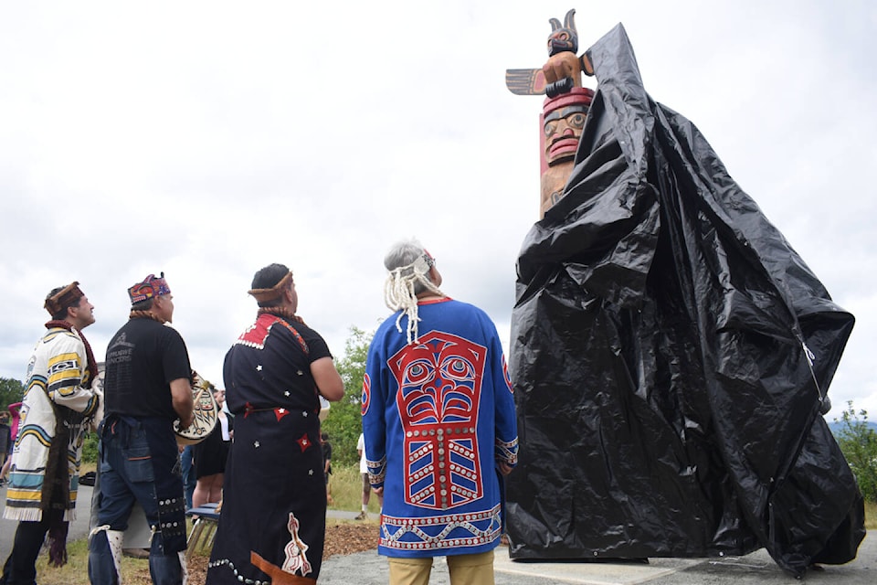 Members of the territories look on as the totem is unveiled. Photo by Terry Farrell.