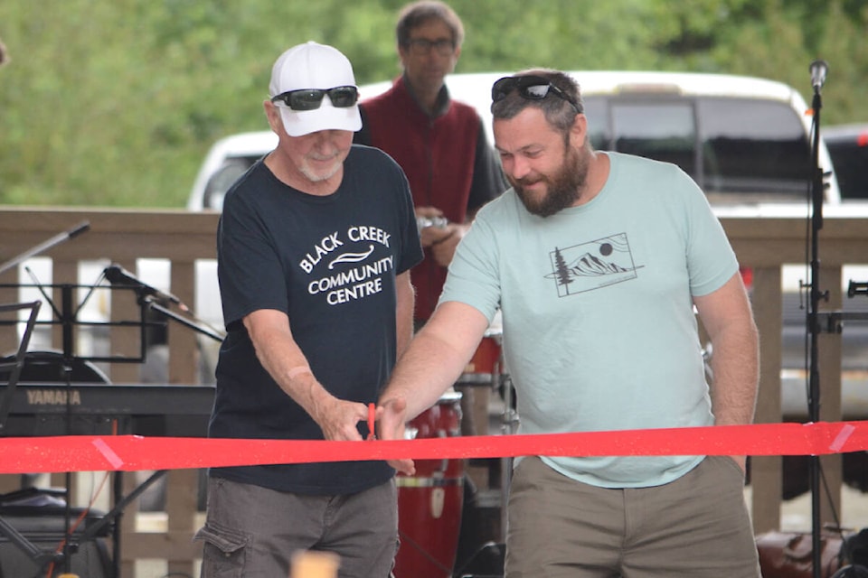 Black Creek Community Association executive members Ian Doe and Chris McPhedran cut the ribbon at the new pavilion. Photo by Mike Chouinard
