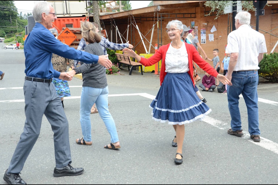 Dance partners were swingin’ round and round at the squaredancing, just one of the many atttractions at Market Day in downtown Courtenay on Saturday. Photo by Mike Chouinard