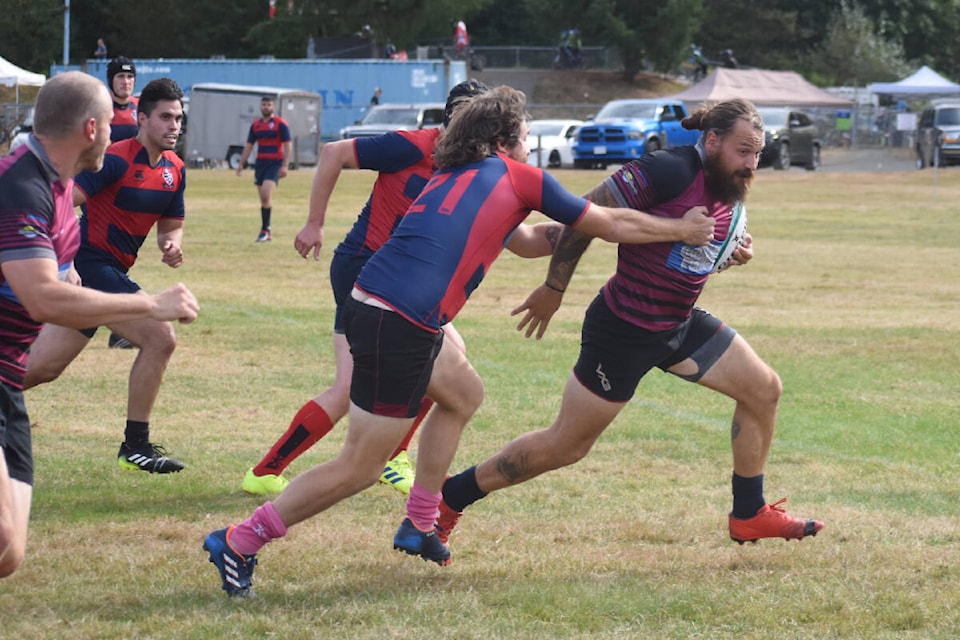 Winger Brandon Hudson runs by an SFU defender during Saturday’s 50-10 Comox Valley Kickers win in men’s rugby action in Cumberland. Photo by Terry Farrell