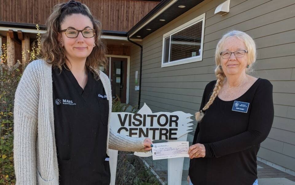 Comox Valley Kin club member Terry Chaney, right, presents Kiersten Shyian, assistant manager of the Rehabilitation Program & Wildlife Care at the Mountainaire Avian Rescue Society (MARS), with a cheque for $1,125. Kiersten administers the Ambassador Bird Program. Photo supplied