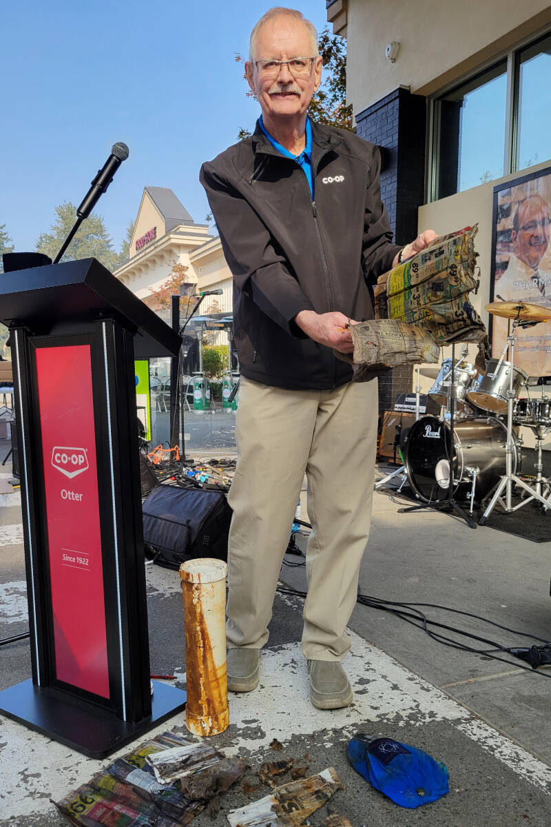 Otter Co-op board of directors president Charlie Fox discovered water had seeped into a time capsule from the 1980s, ruing the contents. It was opened on Wednesday, Oct. 19, at the Langley retail centres its 100th anniversary. (Dan Ferguson/Langley Advance Times)