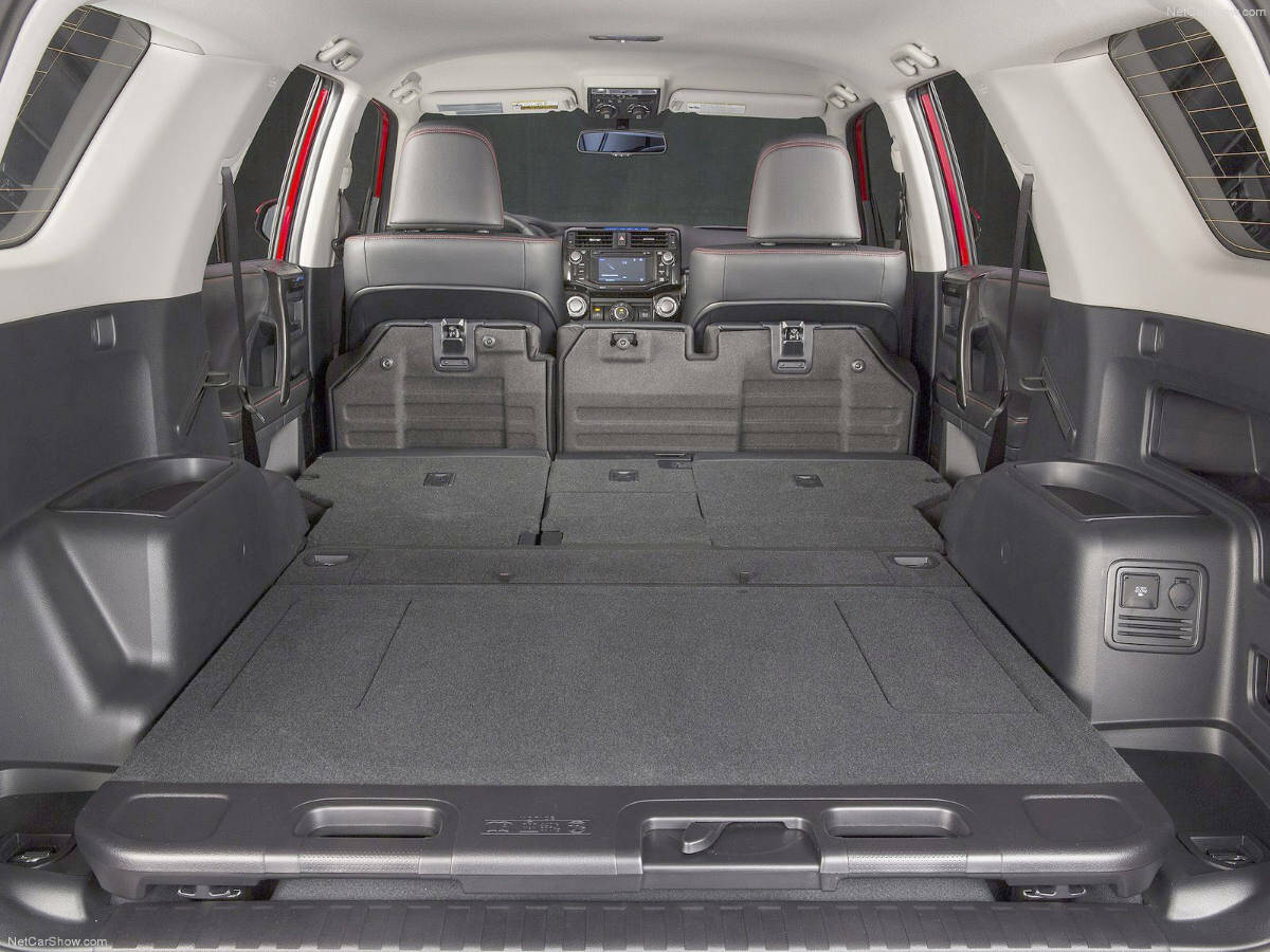 The 4RunnerÂ’s cargo opening is wide, although the wheel housings limit the floor width. Still, bulkier items can rest on top. PHOTO: TOYOTA