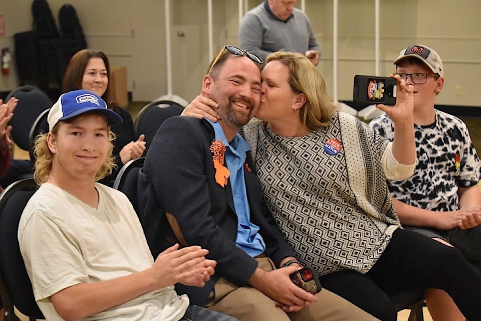 Courtenay Mayor Bob Wells receives a kiss from his wife Michelle after hearing the election results, Oct. 15 at the Filberg Centre. Wells was elected to his second term as mayor.