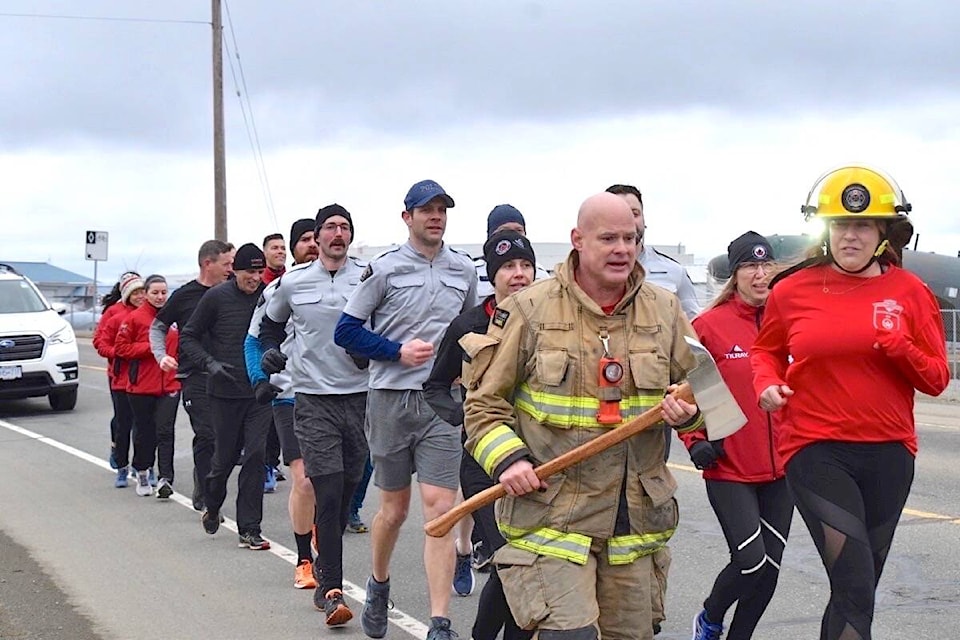 Wounded Warrior team members run along Military Row near the end of a 58-kilometre run that began in Campbell River Wednesday. Scott Stanfield photo