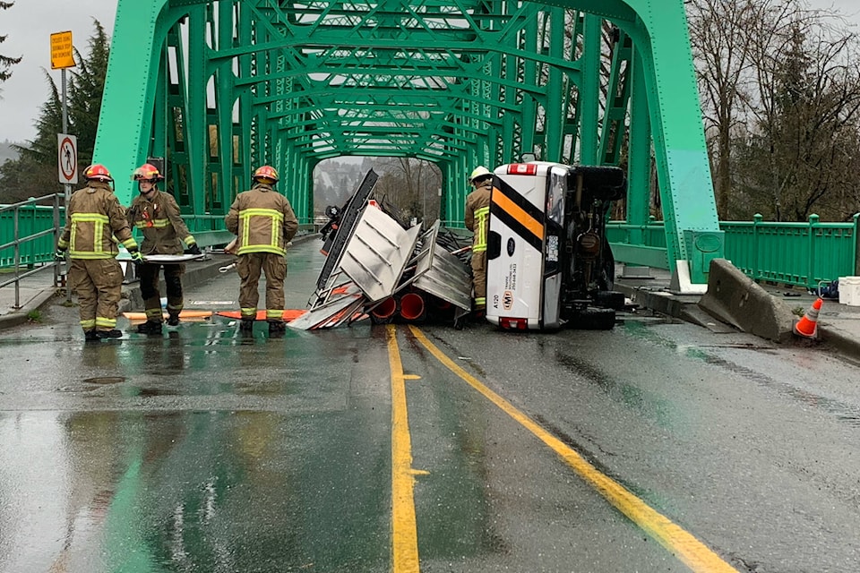 A truck that has flipped on its side has snarled traffic near the Fifth Street Bridge in Courtenay Thursday slowed traffic but no major injuries were reported. Photo by Terry Farrell
