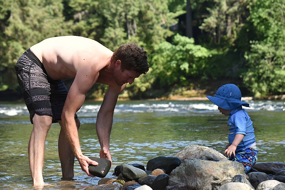 Andrew Howard and his son Ezra enjoy the fine weather by spending their afternoon playing in the river at Puntledge Park on June 12.(Olivier Laurin / Comox Valley Record)