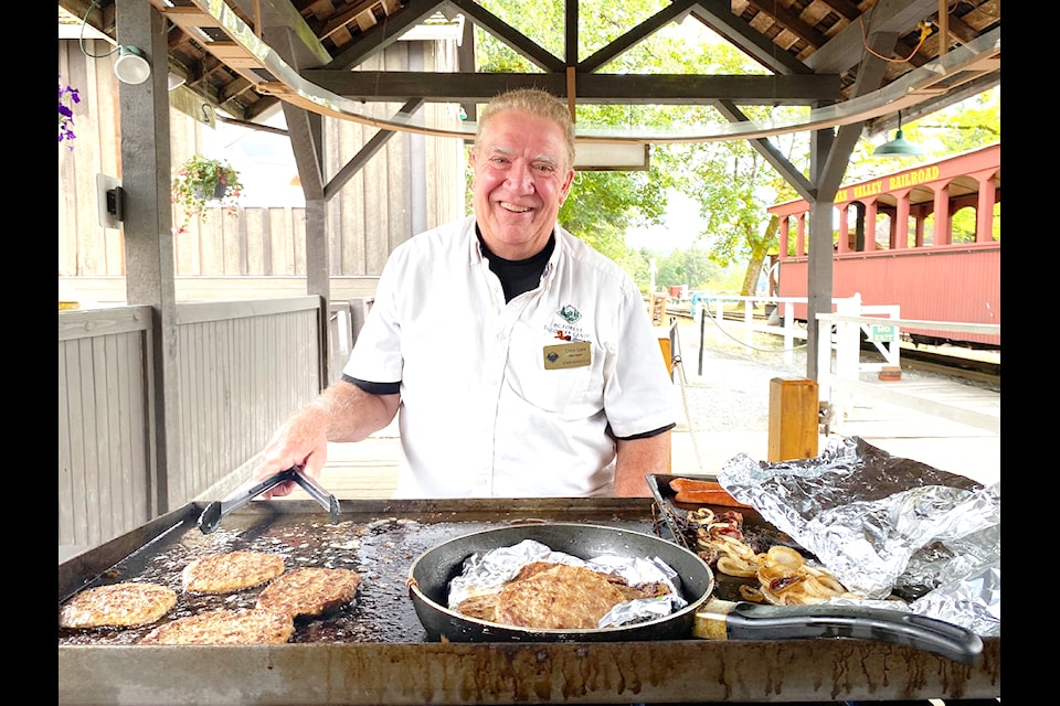 BC Forest Discovery Centre general manager Chris Gale  knows how to manage a grill as well as he does the not-for-profit centre. Gale poses at the grill between serving up a tasty lunch to volunteers on Aug. 20.