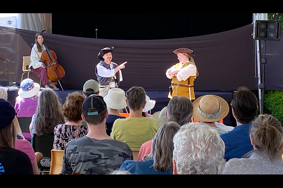 It was a full house at the sneak peek of 'Two Gentlemen of Verona' on the last day of the 39 Days of July at Charles Hoey Park on Aug. 5. Laura Faulkner (left) and Senya Pike play the roles of Valentine and Proteus in one of Shakespeare's earlier works, moved along by the sweet sounds of the cello played by Mary Gallagher.