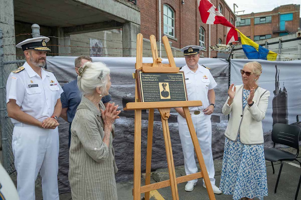 Anne Nolte (left) and Jan Redford (right), relatives of Lieutenant William McKinstry Maitland-Dougall for whom Building D-85, HMC Dockyard, CFB Esquimalt will be named, with Captain (Navy) Alex Kooiman (rear right), commander Canadian Submarine Force, and Rear Admiral Christopher Robinson (rear left), commander Maritime Forces Pacific, unveil the new building plaque during a ceremony at the building on Aug. 2, 2024.

Photo: Corporal Jay Naples, MARPAC Imaging Services
